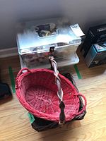 Photo of red and brown wicker baskets stacked on each other next to the storage bin with lock.