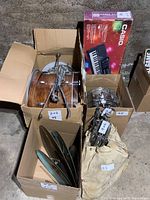 Five boxed musical instrument components on concrete floor