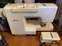 Elna sewing machine profile with foot pedal visible on floor