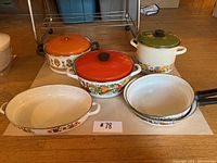 Full set of Rustria enamel cookware including pots, pans, and baking dish, shown with lids on.