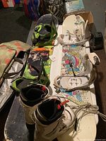 Photo showing two snowboards with bindings and a pair of snow boots