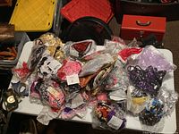 Overview of over 60 new bikinis and lingerie pieces all sealed in plastic bags, assorted colors and patterns visible.