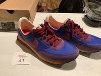 Pair of vintage Nike Elite running shoes shown with box, bright blue and red colors, size 11 label visible on box.