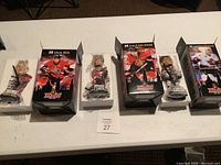 Four Ottawa Senators 2016-2017 bobblehead collectibles on table with packaging and plastic wrap.