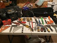 Full view of all hand tools laid out on table with the black AWP HP tool bag behind them