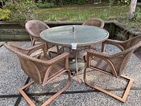 Full set of round table with four chairs on patio surface