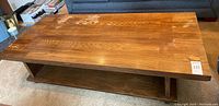 Angled top view showing the wood grain pattern and finish of the coffee table surface.