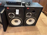 Overview of both JBL speakers with covers removed, Recoton speaker selector and Archer amplifier on top