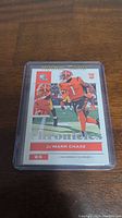 Front of the Ja'Marr Chase rookie card with full color image of player in game action and close-up headshot.