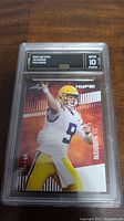 Front of 2020 Leaf Joe Burrow rookie card showing player action image and GMA grading label with Gem MT 10.