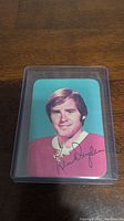 Front side of Ken Dryden hockey card showing portrait photo and printed signature.