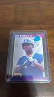 Front of 1989 Donruss Ken Griffey Jr rookie baseball card showing player in Mariners uniform holding bat.