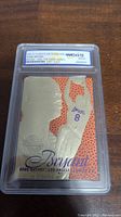 Front view of the graded Kobe Bryant rookie card in gold foil with embossed image and WCG 10 grading label.