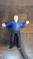 Front view of LJN Bobby "The Brain" Heenan wrestling action figure showing blue shirt with initials and black pants.