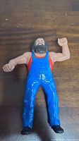 Front view of the plastic Hillbilly Jim action figure, showing facial details, red shirt and blue overalls.