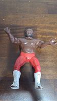 Front view of LJN Junkyard Dog figure in red tights, white boots, with arms raised.
