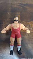 Front view of LJN Ted Arcidi wrestling action figure showing red singlet, black hair and mustache, muscular build