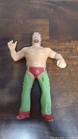 Front view of LJN Terry Funk action figure showing red trunks, green boots, muscular body and facial details.