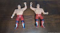 Front view of two British Bulldogs wrestling figures with red trunks and blue knee pads.