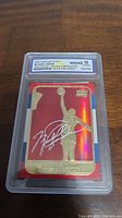 Front view of the 1998 Fleer 23KT Gold Michael Jordan Red Holo Refractor card in graded slab.