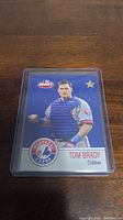 Front photo of Tom Brady Montreal Expos catcher baseball card showing player image and team logo.