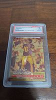 Front of graded card showing 2000 Fleer Ultra Polychrome Gold Refractor Tom Brady with PSA grade label 10