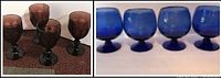 Four dark smoky glass goblets shown side by side on a carpeted surface.