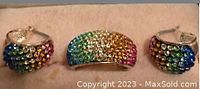 Photo showing a ring and matching hoop earrings set adorned with multicolored rhinestones arranged in rows.