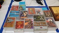 Top view showing all 12 trading card packs arranged on a table, various fantasy and pop culture themes visible on card pack covers.