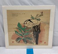Front view of the Chinese ink on rice paper painting depicting a tree stump with green leaves and red berries against a warm earth tone background, mounted on a mat board.