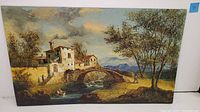 Front view of Morris Katz oil painting on masonite depicting European folk countryside with river, stone bridge, houses, trees and figures.