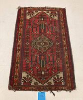Full view of vintage Turkish rug showing overall pattern and condition with edge wear and some fraying.