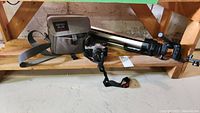 General overview of camera, bag, tripod on wooden shelf