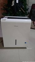 Front view of Classic dehumidifier in white with control panel at the top showing Classic brand logo and water level window.