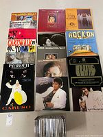 Photo showing front covers of 14 vinyl LP albums and a row of CDs below them.