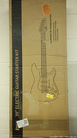 Sealed cardboard box labeled ‘39" Electric Guitar Starter Kit’