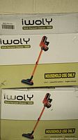 Two boxed Iwoly Stick Vacuum Cleaner V600 units stacked showing front packaging with vacuum image and model information.