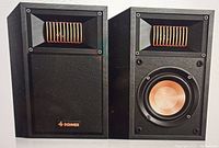 Pair of Donner bookshelf speakers showing front design with copper-colored woofer and horn tweeter, one speaker with grille and logo visible, black rectangular cabinet finish.