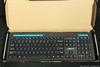 Opened box showing LANGTU branded keyboard with cyan blue function keys and black body.