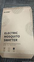 Box with AVJONE Electric Mosquito Swatter branding and product details.