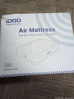 Packaging box for IDOO Air Mattress Queen Model R-M002 showing brand, model, and product illustration.