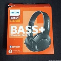 Front view of Philips Bass+ wireless on-ear headphones box showing branding and product image.