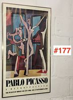 Full front view of framed poster against wall
