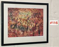 Full view of framed artwork by Sol Levenson hung on white brick wall with red lot number sticker visible