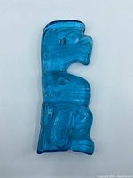 Top view showing the blue translucent glass totem wall plaque with detailed indigenous design patterns.