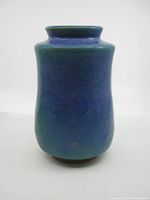 Front view of the blue-green vintage pottery vase showing cylindrical shape and glaze