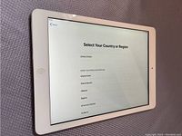 Apple iPad front screen displaying setup country selection menu