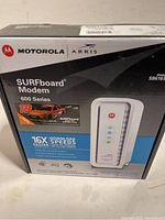 Box front showing Motorola Arris branding, SURFboard Modem 600 Series model SB6183 with an image of the modem and race car graphics.
