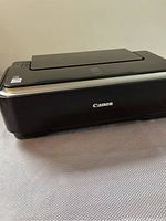 Exterior of Canon IP2600 printer showing Canon logo on the front black casing.