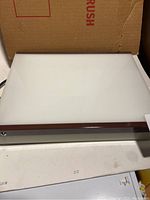 Image showing top view of the desktop light box with white translucent surface and wooden frame.